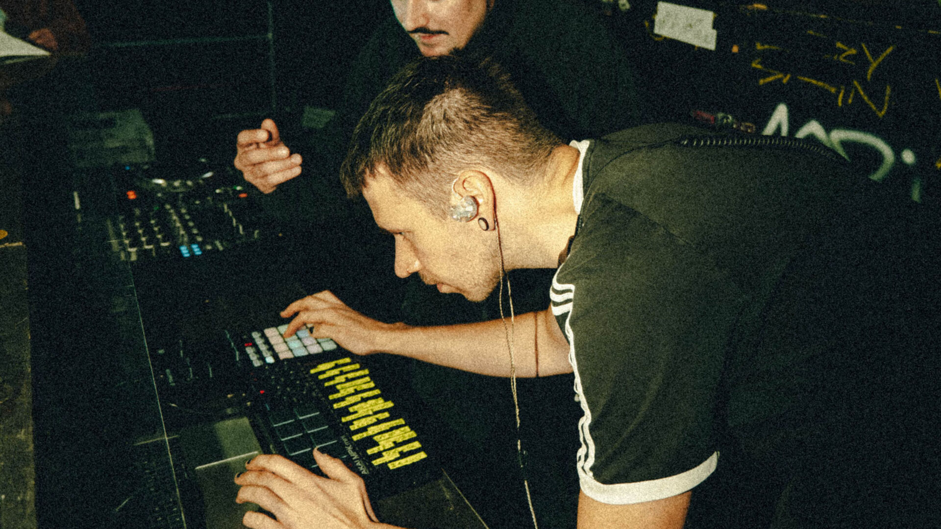2 Sound Engineers photgraphed from above looking at a mixing desk